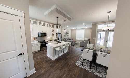 Open concept townhome with vinyl plank flooring, floating kitchen island, and more