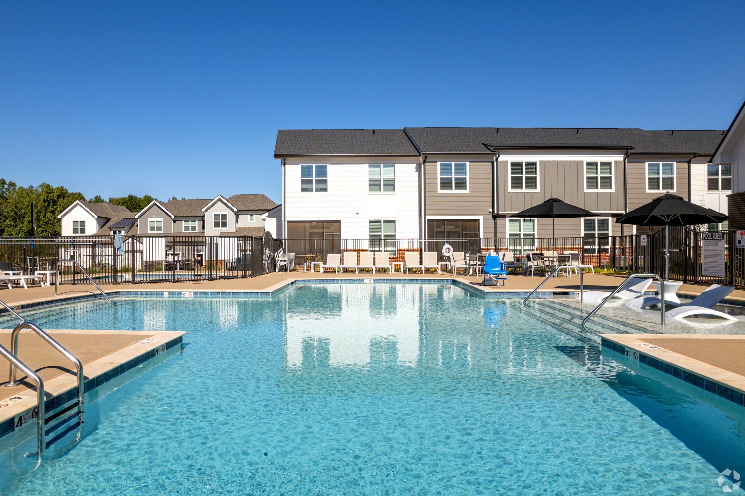 The Townhomes at Bridlestone outdoor pool with surrounding townhomes