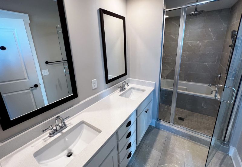 Townhomes at Bridlestone bathroom interior with double sink and vanity and modern appliances