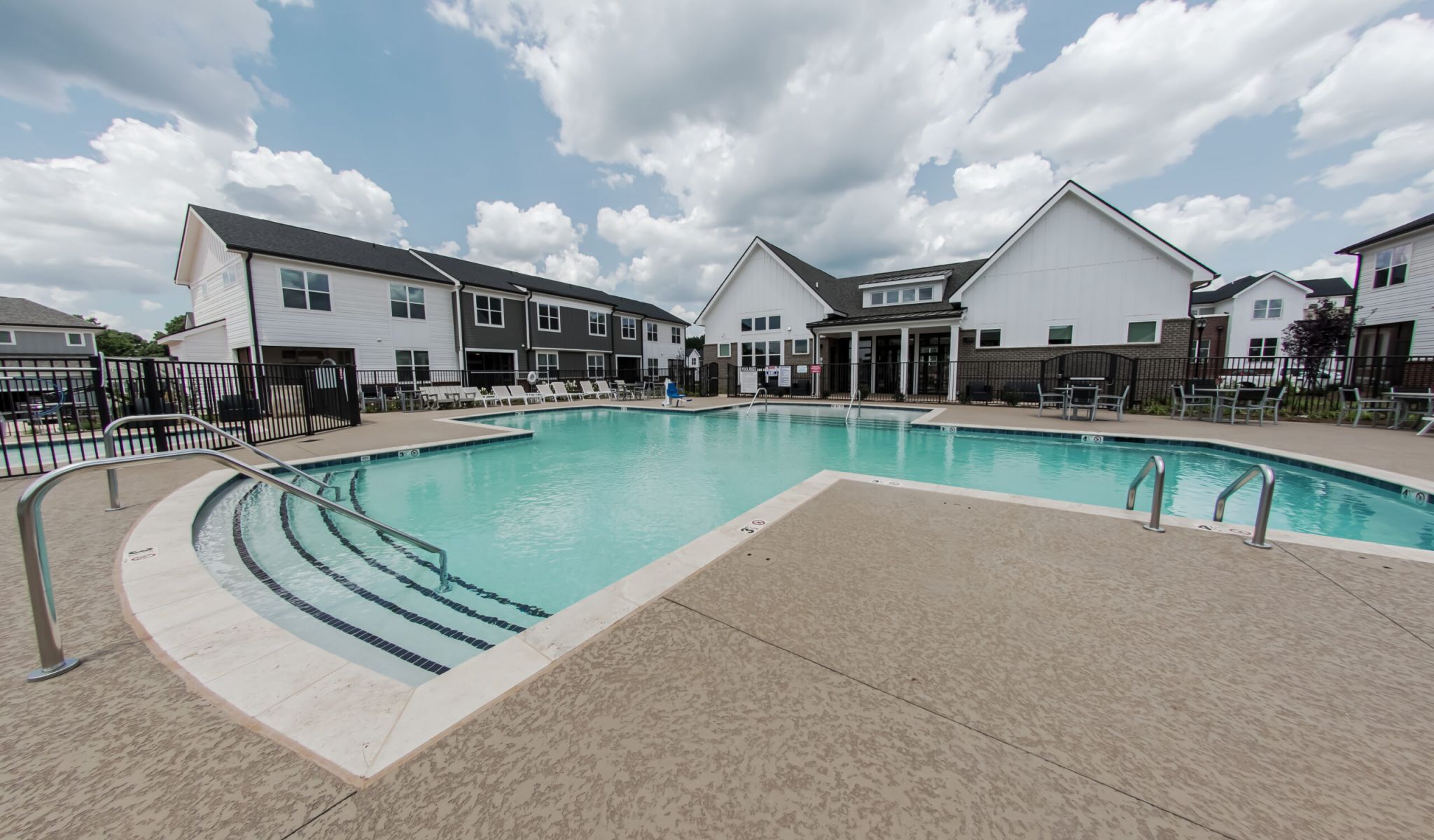 Townhomes at Bridlestone luxury community pool with lounge chairs