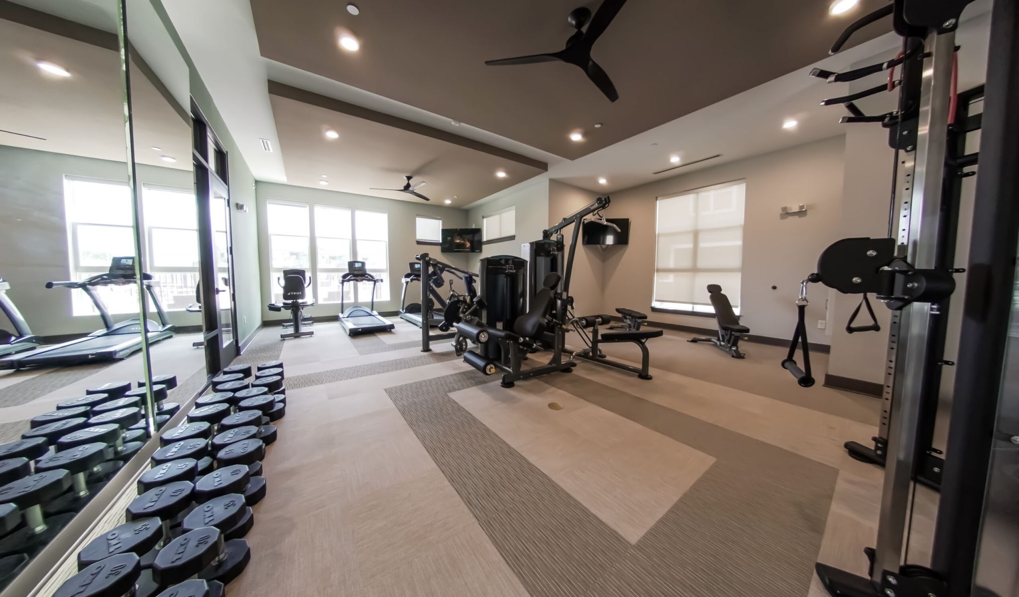 Townhomes at Bridlestone fitness center with weights and cardio equipment