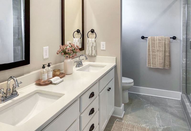 Townhomes at Bridlestone bathroom interior with double sink and vanity and modern appliances