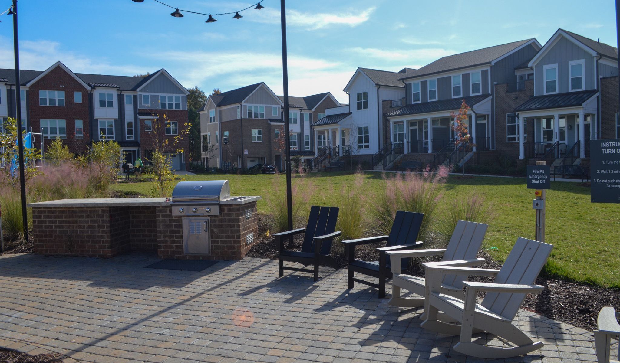 Townhomes at Bridlestone outdoor community grilling stations with lounge chairs and firepit