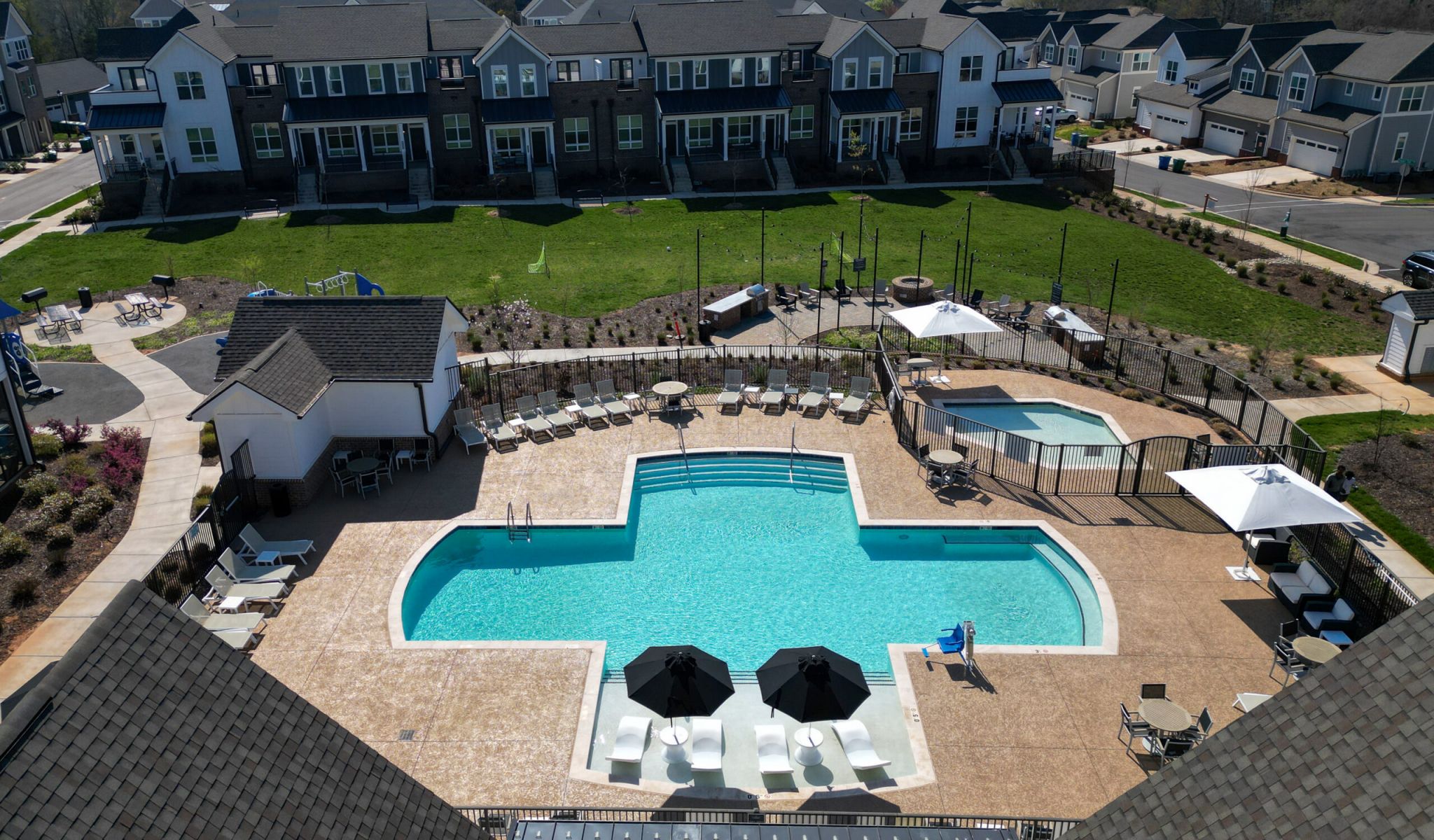 Townhomes at Bridlestone luxury community pool with lounge chairs