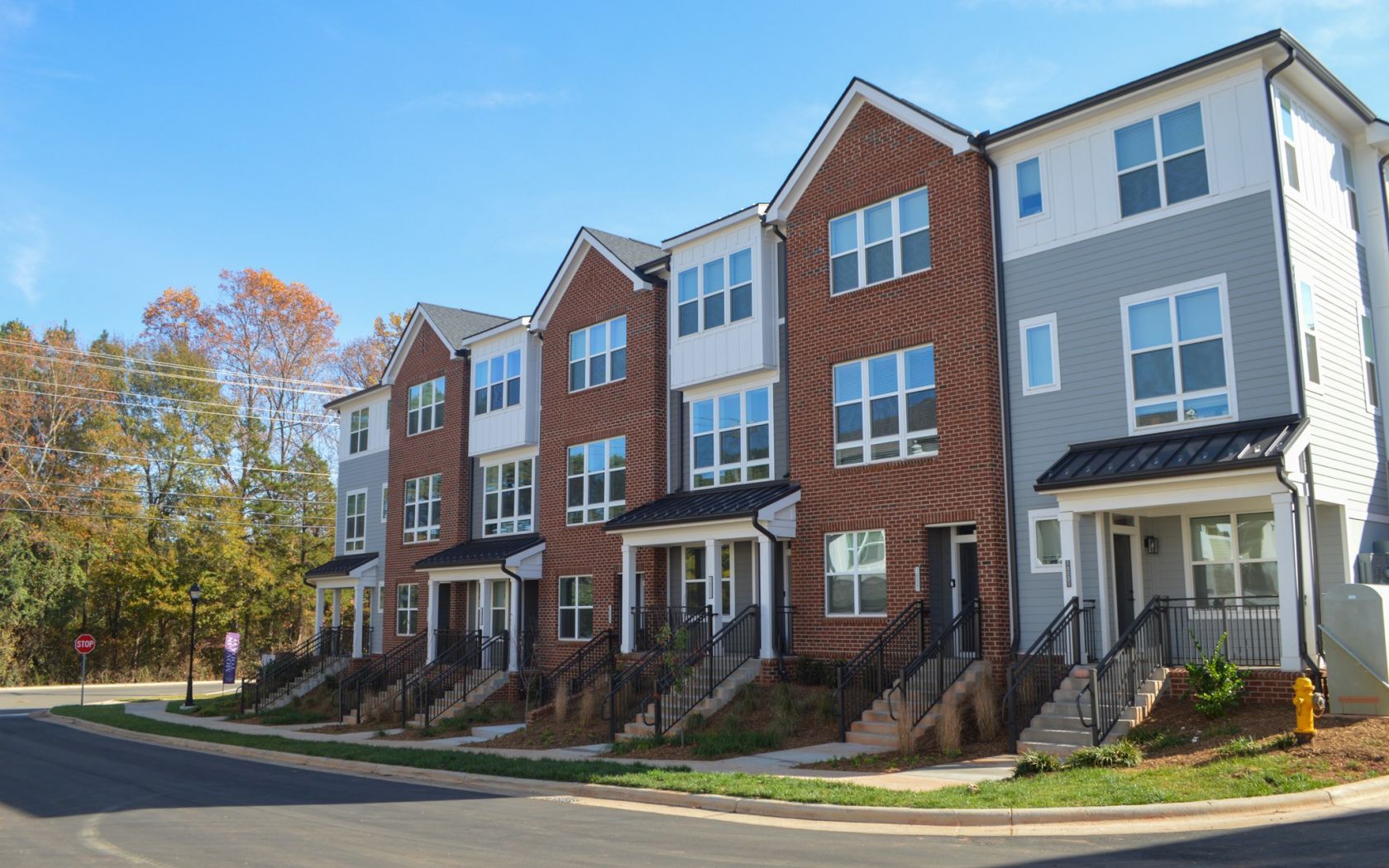 Exterior view of townhomes in Pineville, NC with blue sky in the background