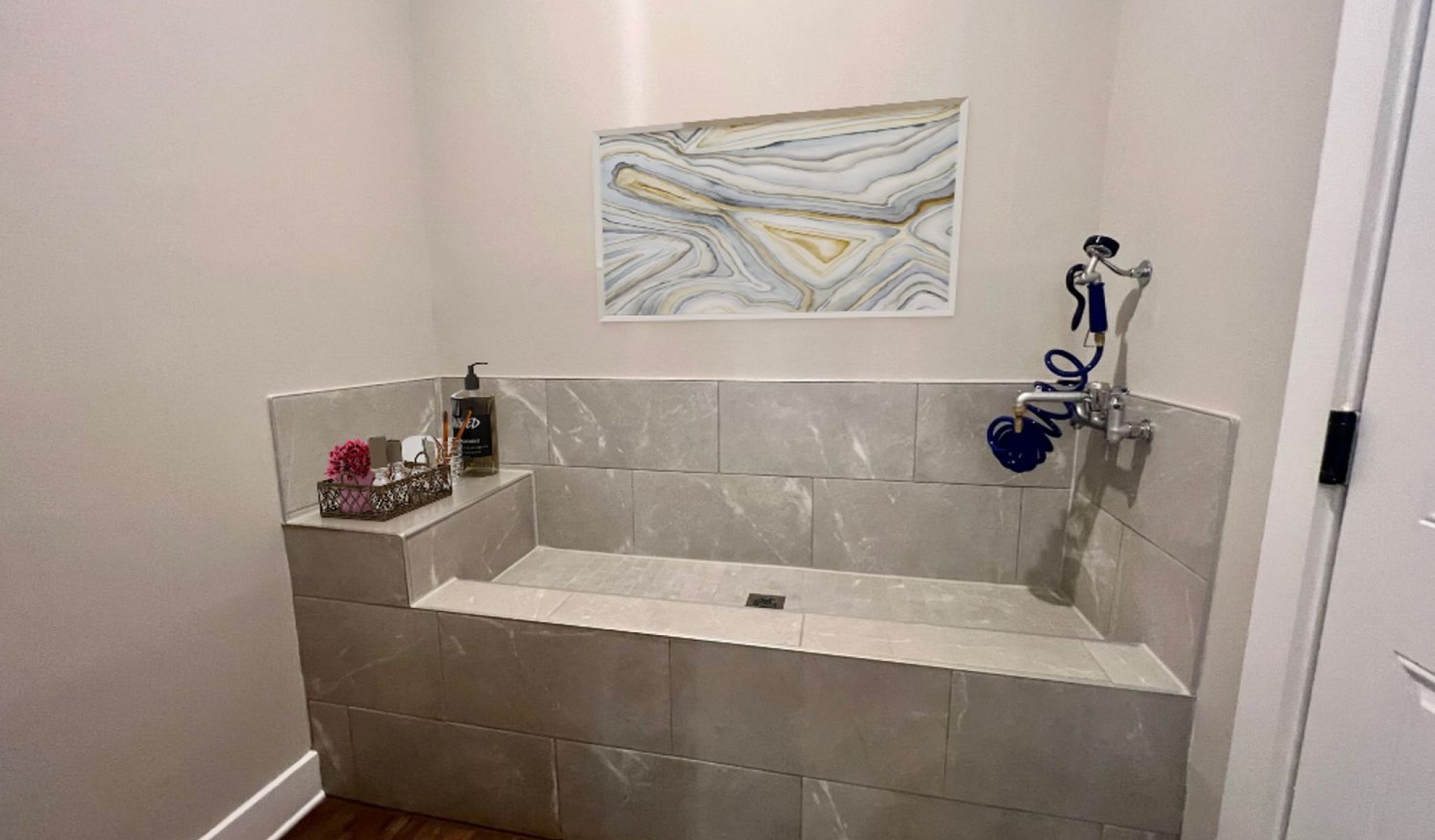 Townhomes at Bridlestone large soaking tub with marble tile backsplash in modern bathroom
