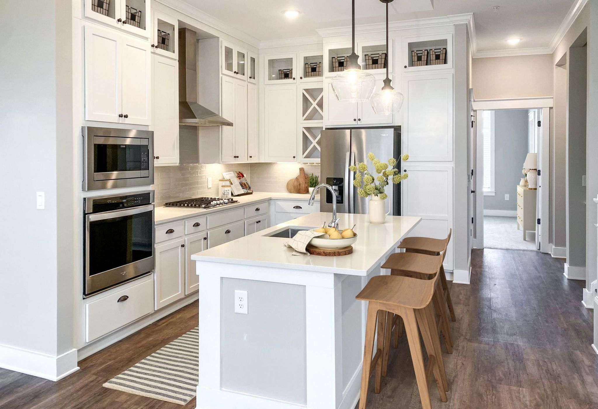Beautiful luxury townhome kitchen with island, stainless steel appliances, wine storage, and more