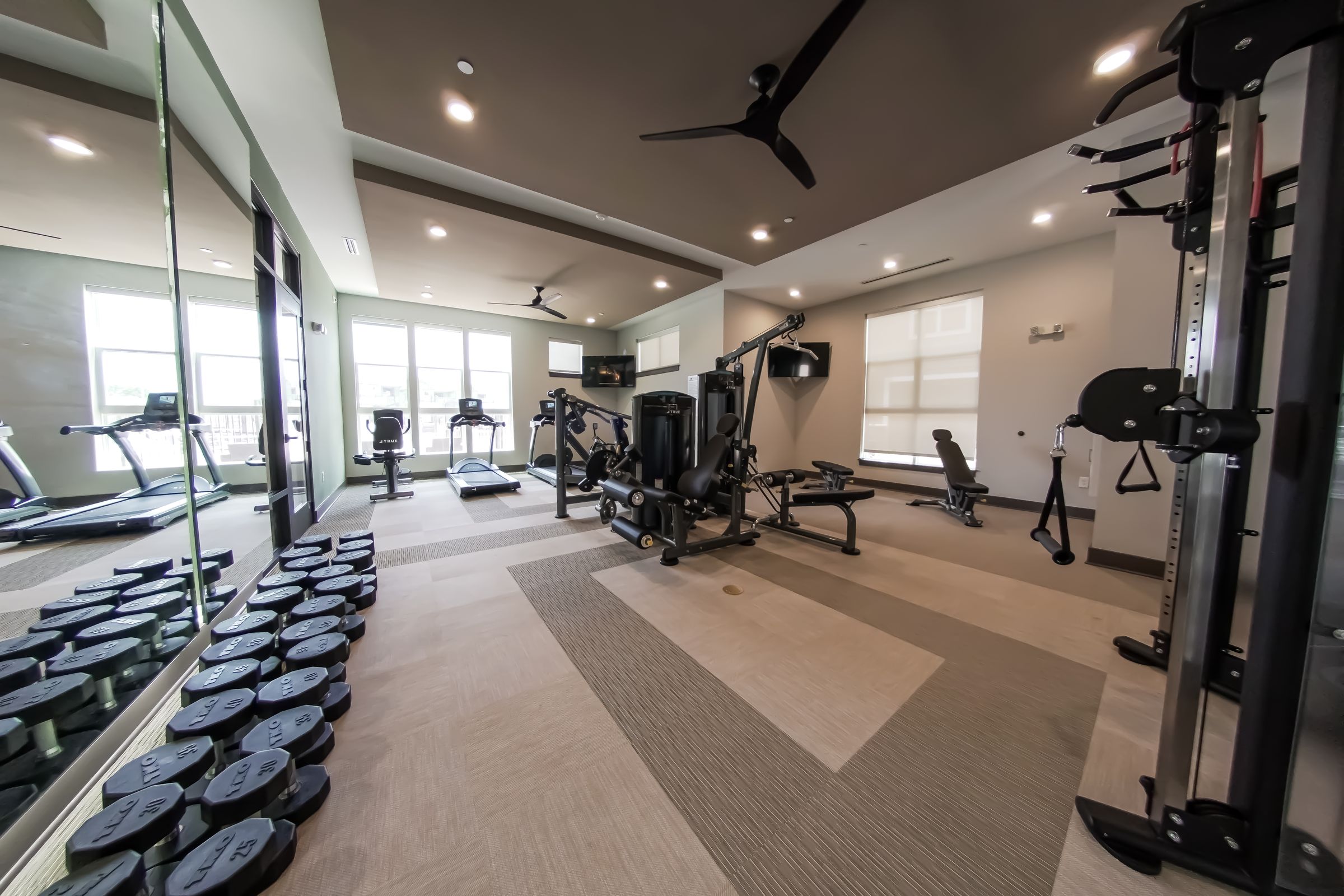 Townhomes at Bridlestone fitness center with weights and cardio equipment