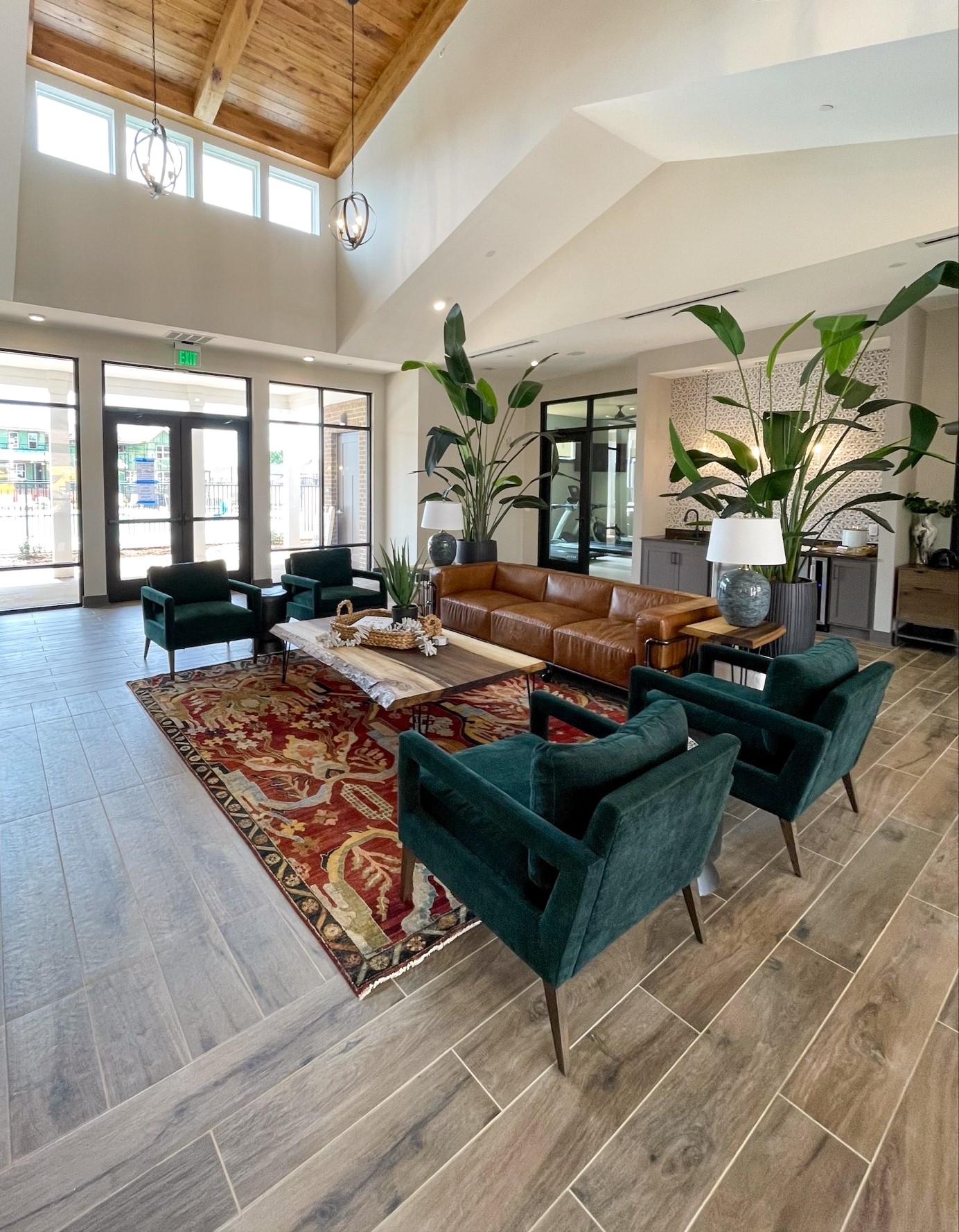 Townhomes at Bridlestone community clubhouse furnished with couches, coffee tables, and plants and beautiful finishes