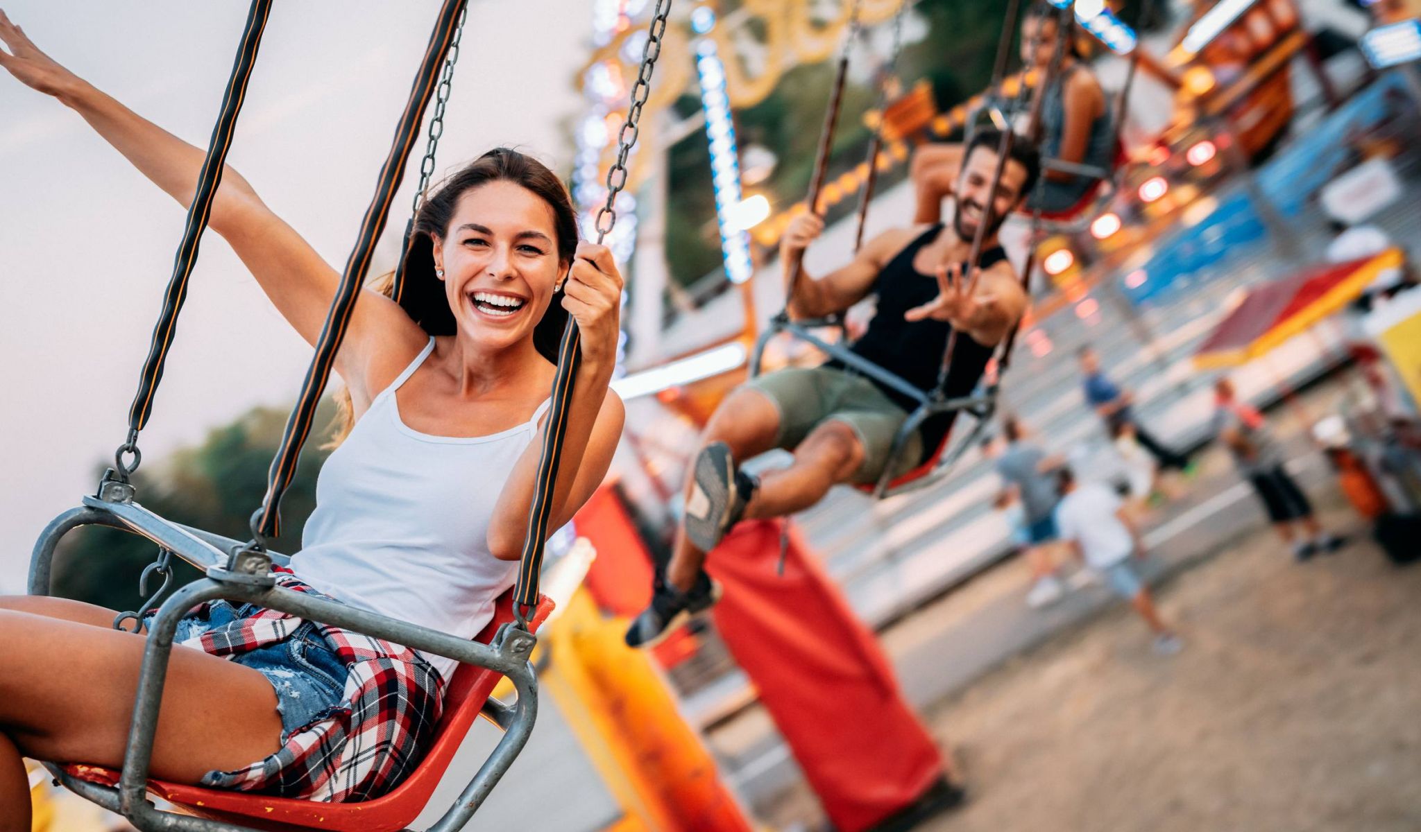 Young woman at a theme park on a swinging ride
